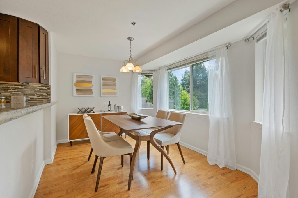 A dining area with hardwood flooring.