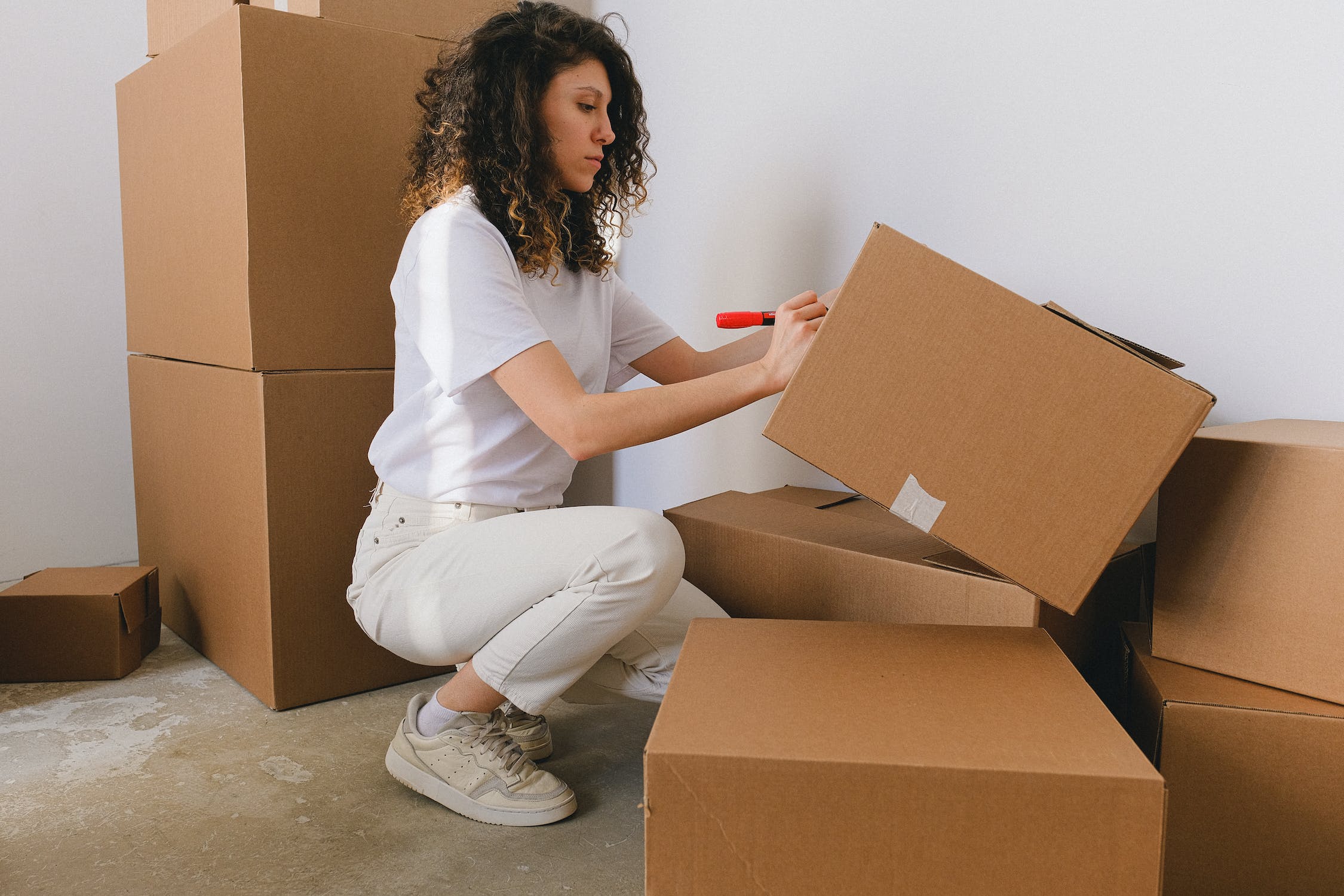 woman putting label on a box
