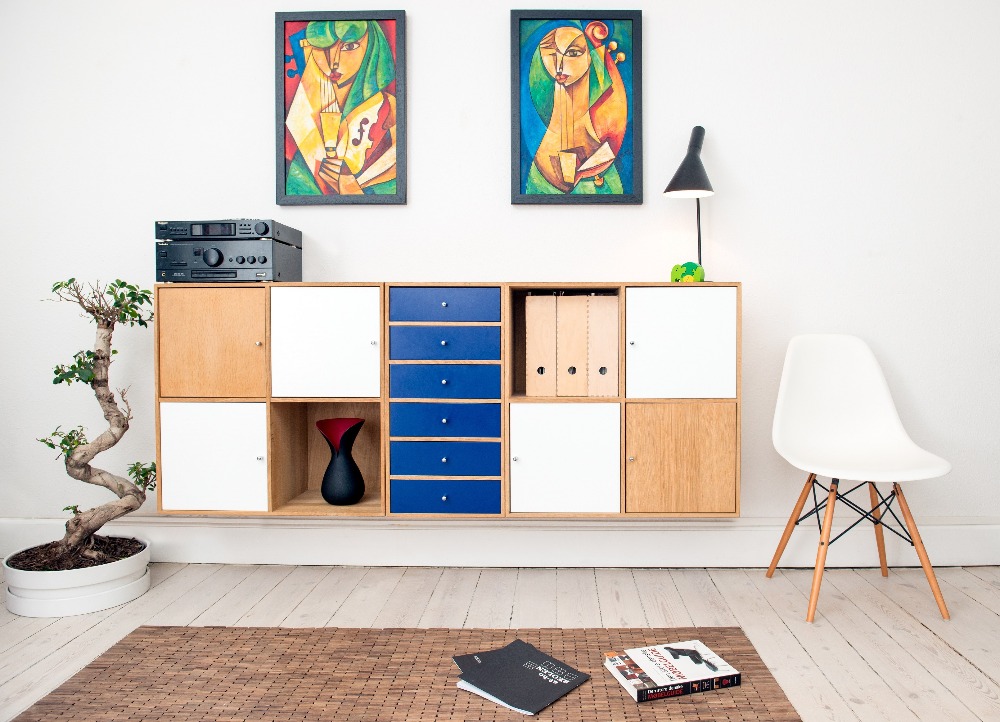 abstract paintings above cabinet