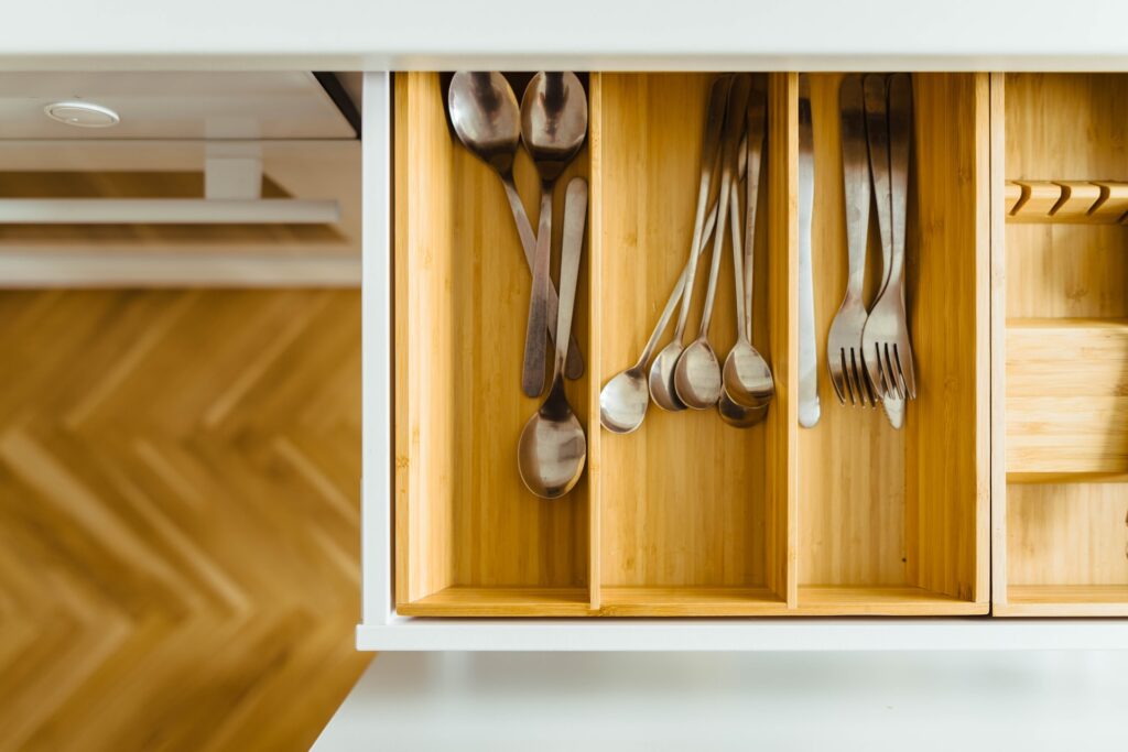Wooden kitchen drawers with silverware sorted