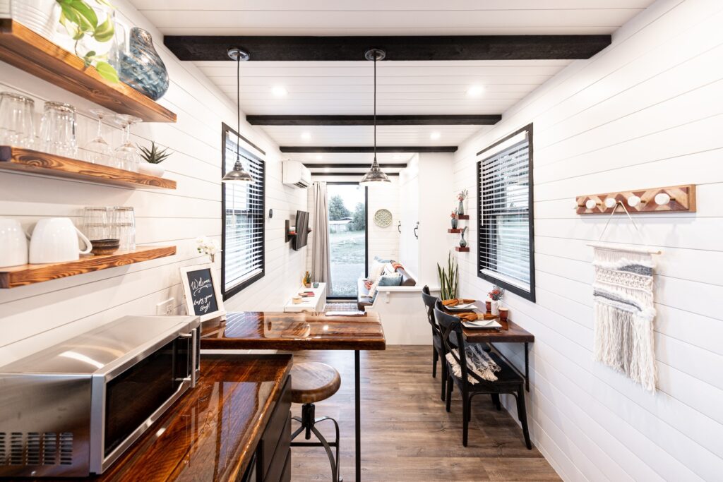 Interior of a tiny house with simple white and wood-toned accents.