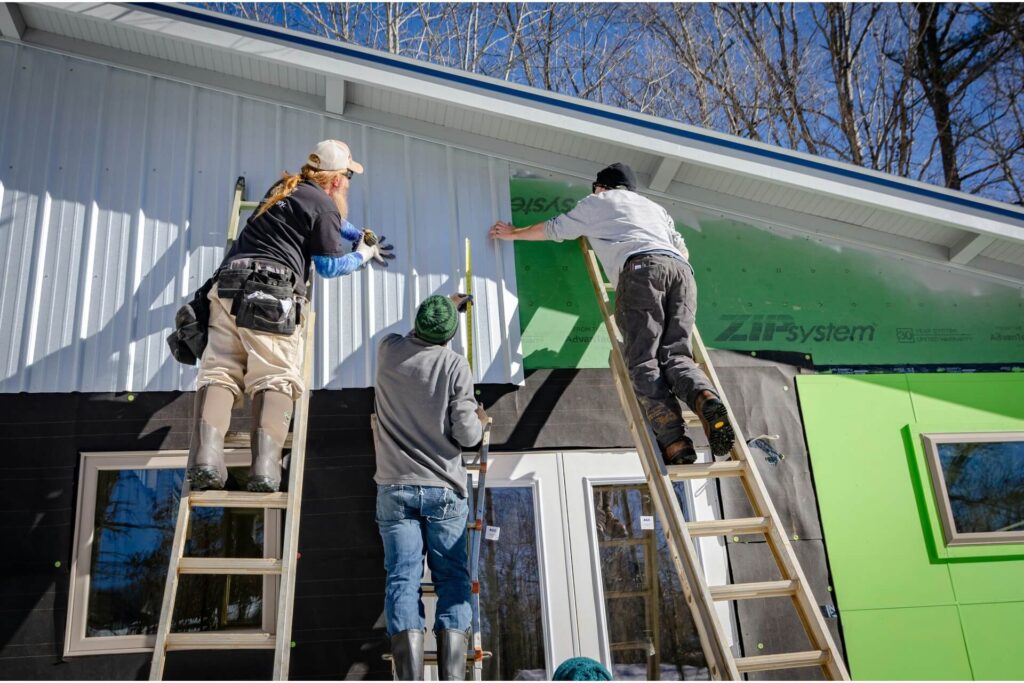 Siding installers at work.