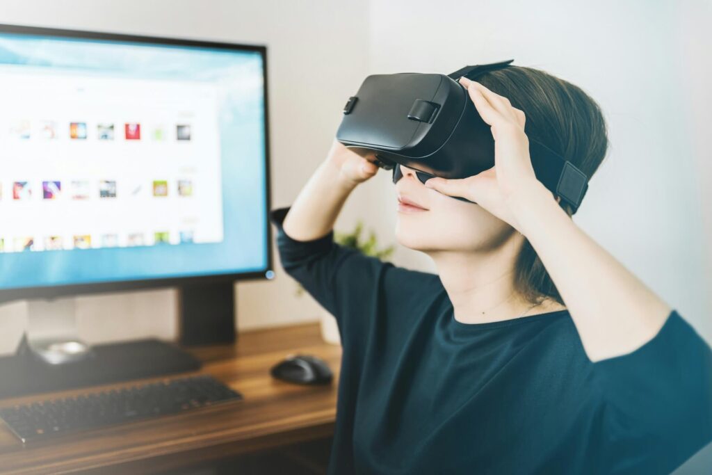 A female employee wearing a VR headset to interact with remote co-workers