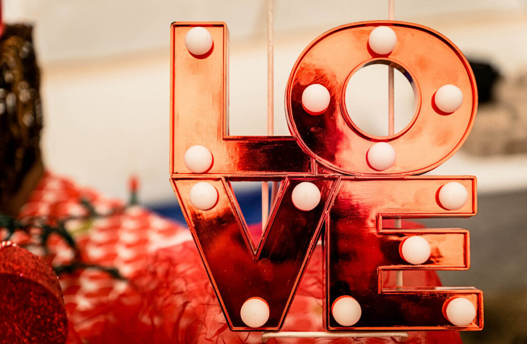 red sign that spells love