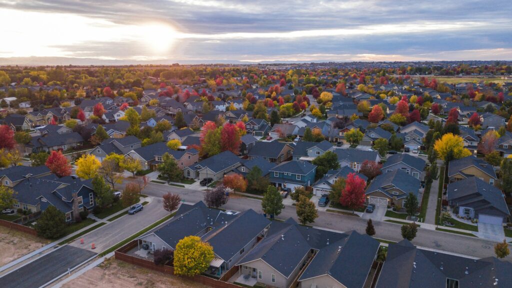 aerial view of houses with trees changing colors