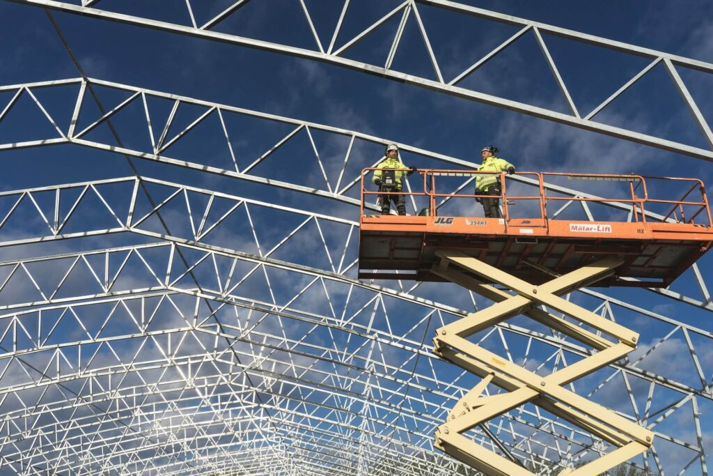 Two construction workers on a crane