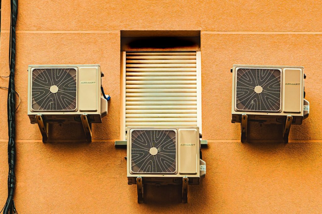 A black and gray box fan attached to a home