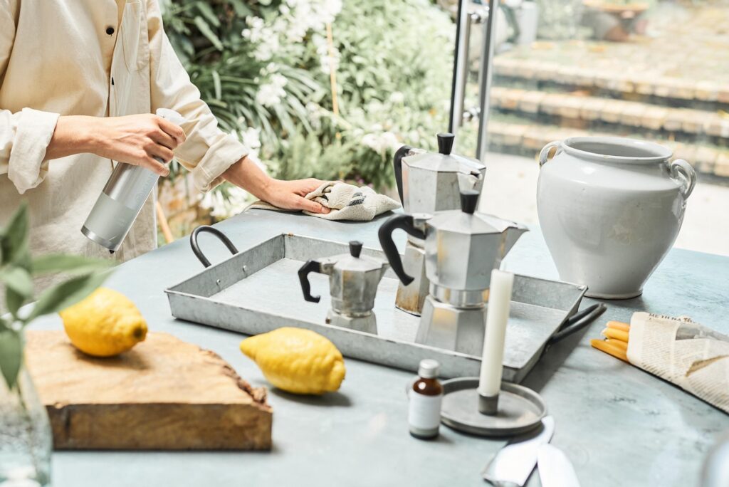 A woman wiping down a counter with a rag