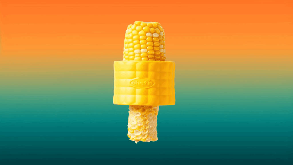yellow corn stripper around a corn on the cob in front of an orange and teal background