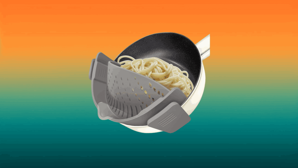 gray strainer clipped on a pot of noodles in front of an orange and teal background