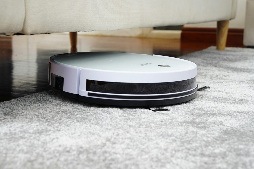 Vacuum cleaner cleaning gray carpet