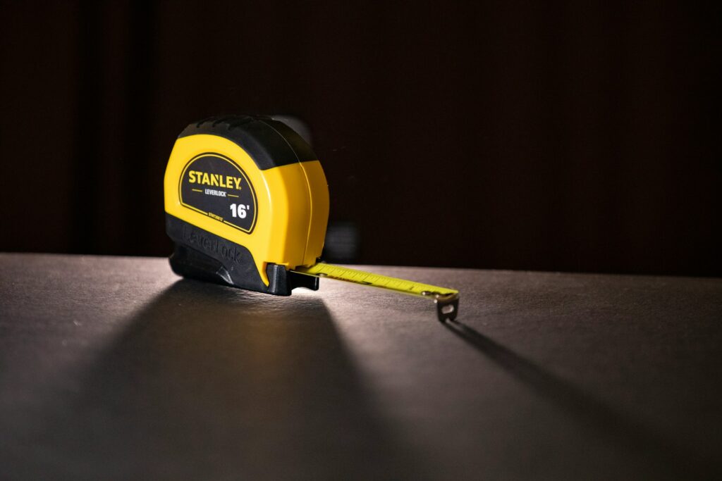 A yellow Stanley tape measure.