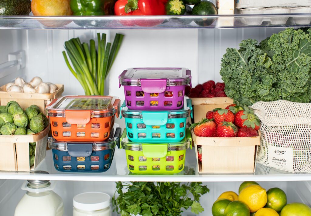 an organized fridge with fresh veggies
