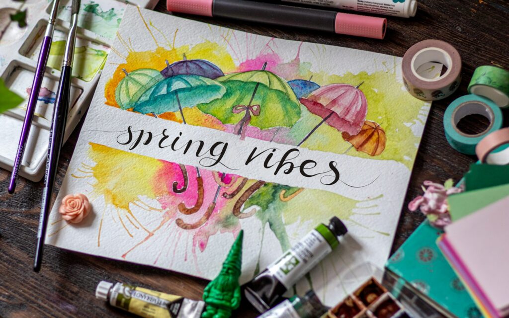 multi-colored painting that says "spring vibes"