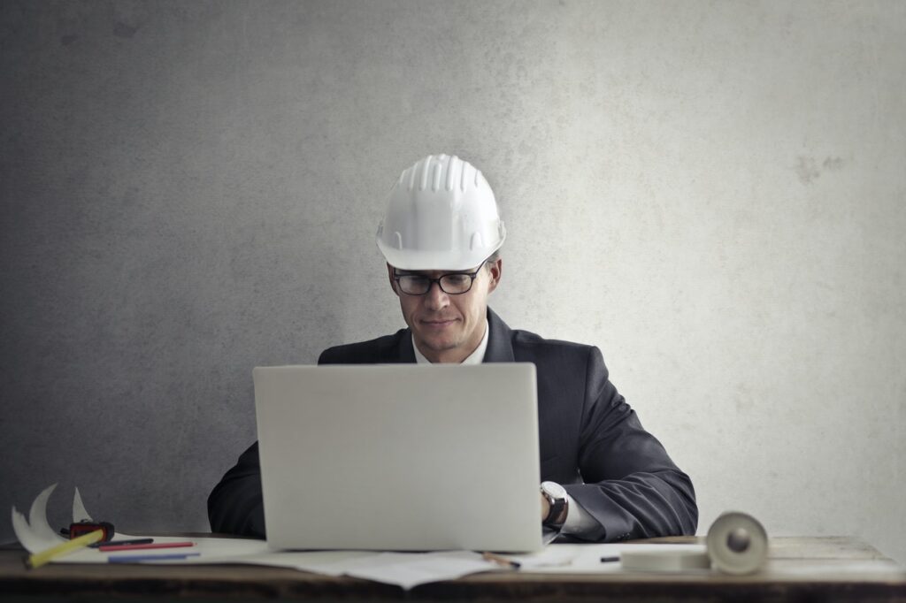 construction professional at laptop