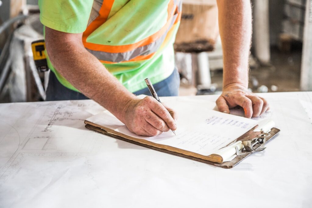 construction professional using clipboard
