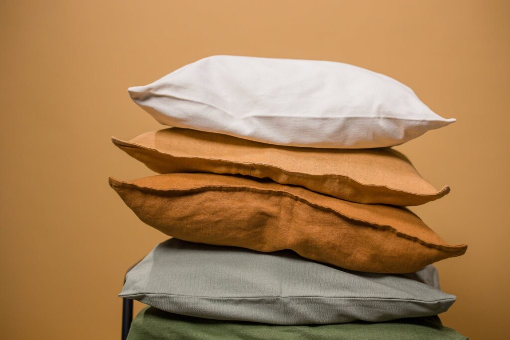 stacked pillows with a neutral background