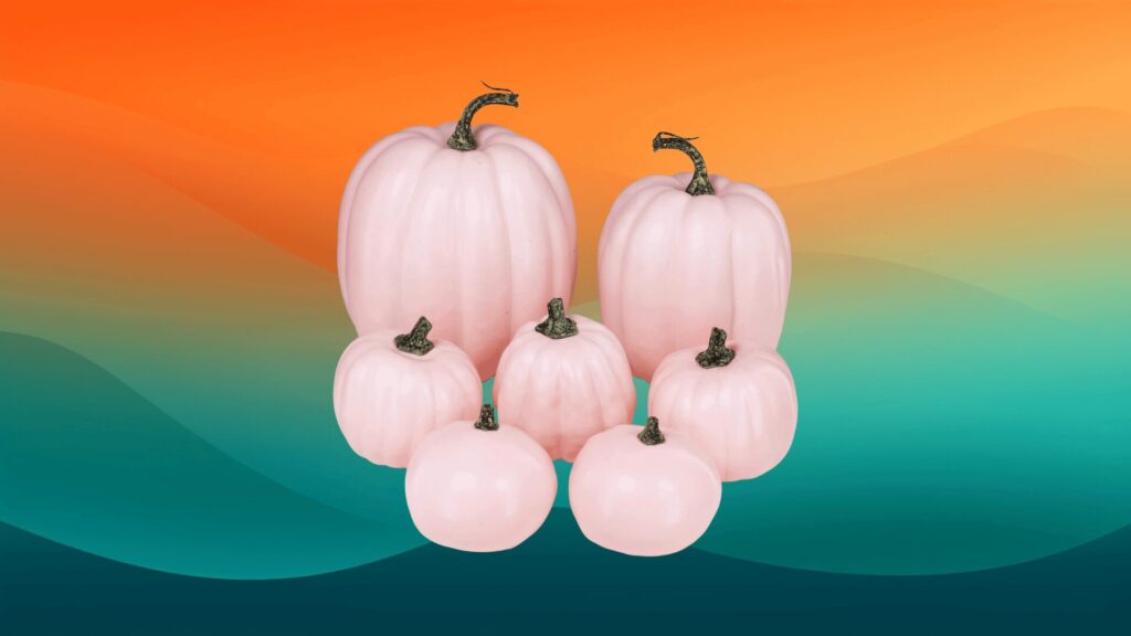 pink Halloween decor pumpkins in front of an orange and teal background
