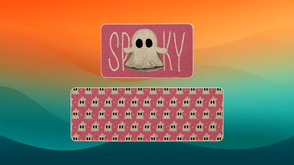 pink Halloween decor kitchen mats with ghosts in front of an orange and teal background
