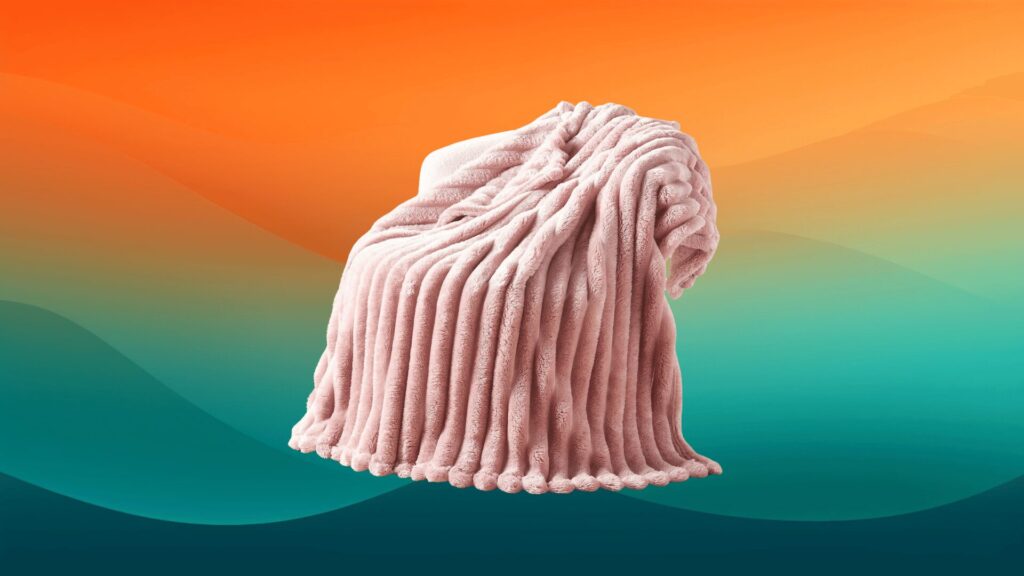 pink fuzzy blanket on top of a chair in front of an orange and teal background