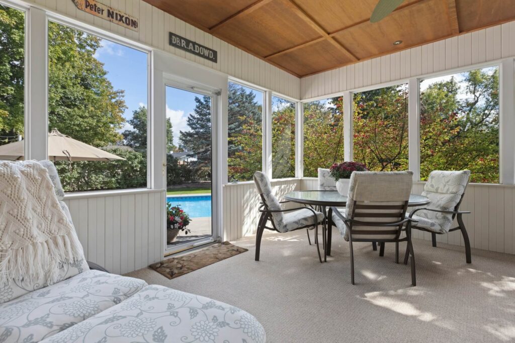 A sunroom furnished with comfortable furniture