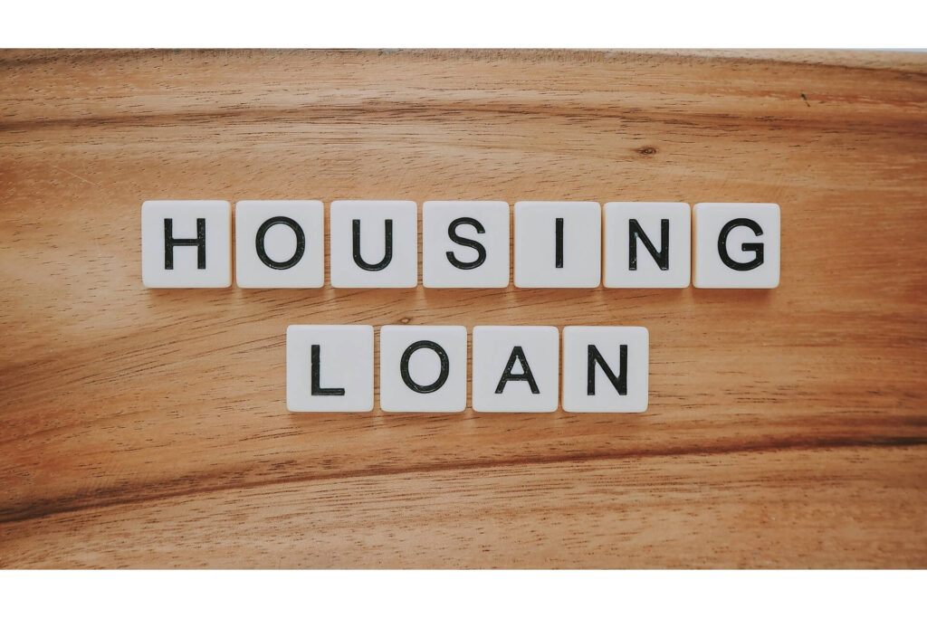 Scrabble tiles spelling housing loan.