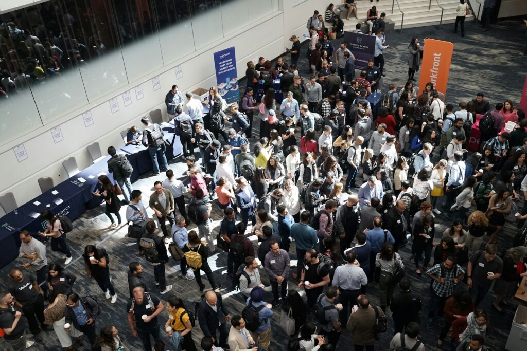 Crowd of people networking at a conference for career advancement opportunities