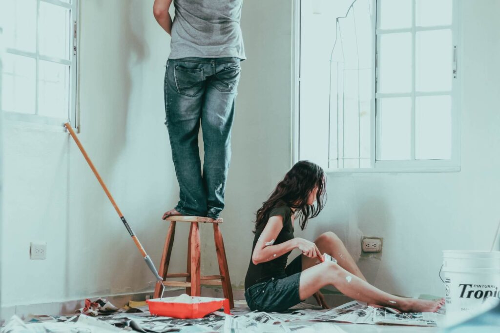 A couple of do-it-yourselfers painting home interior walls.
