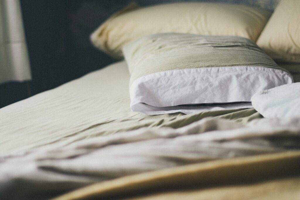Pillows in cases laying on a bed