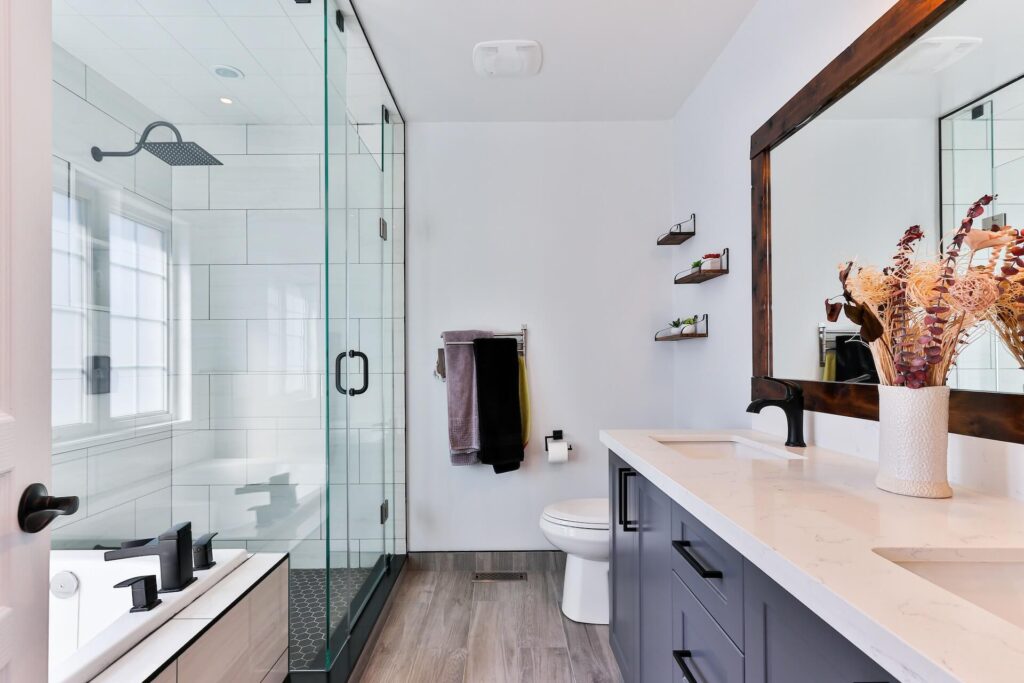 Bathroom with glass-door shower, white sink and a hot tub.