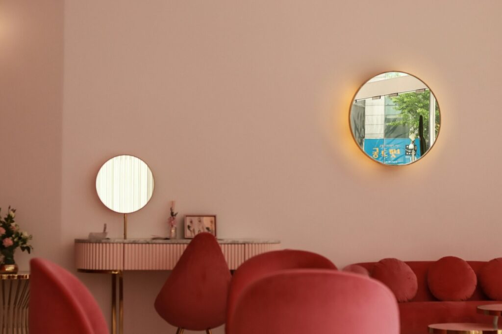 Soft tan walls take on a warm hue thanks to the warm pink seats and gold trim.