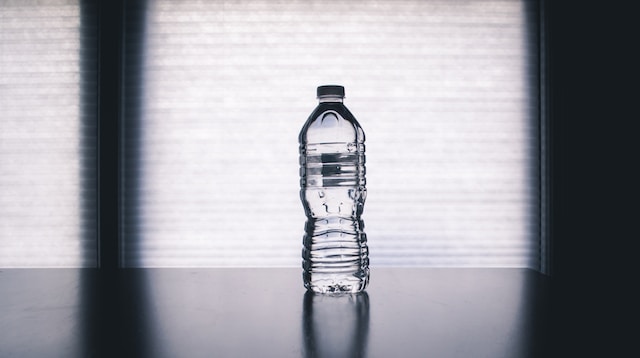 Plastic water bottle in window sill.