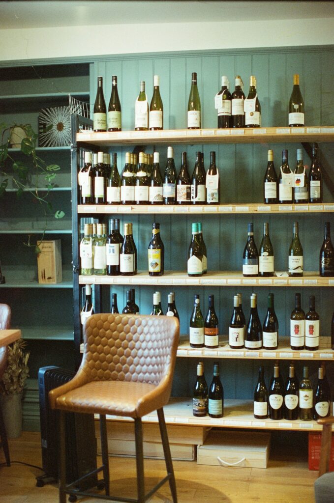 wine bottles on a bookshelf as a bar