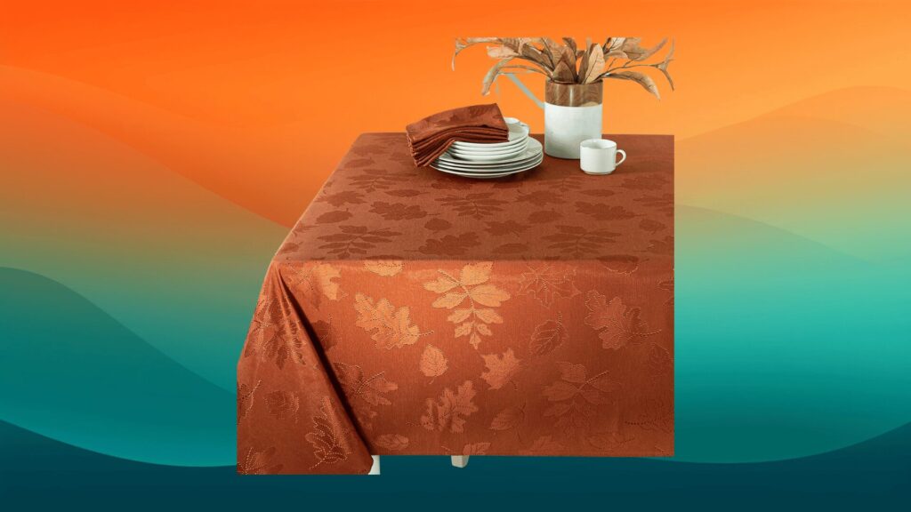 orange fall tablecloths with leaves in front of an orange and teal background