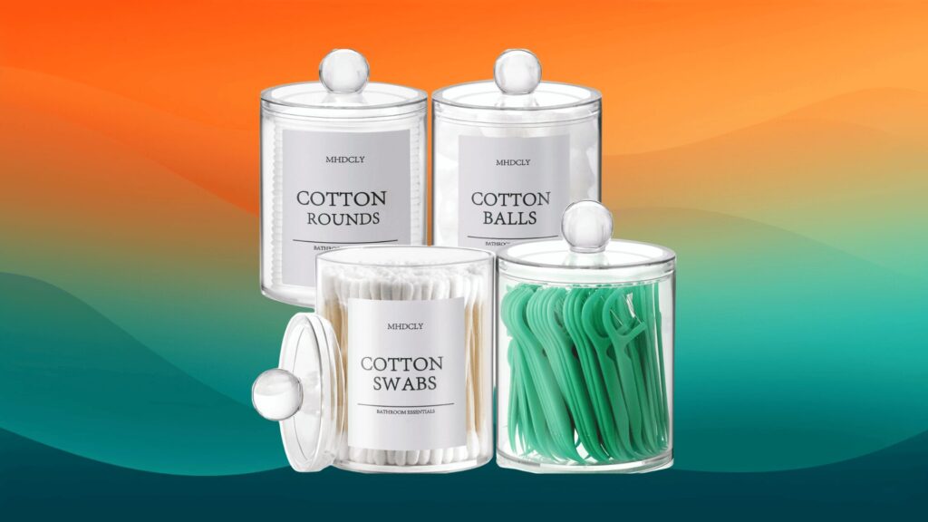 four clear containers filled with cotton rounds, cotton balls, cotton swabs, and floss in front of an orange and teal background