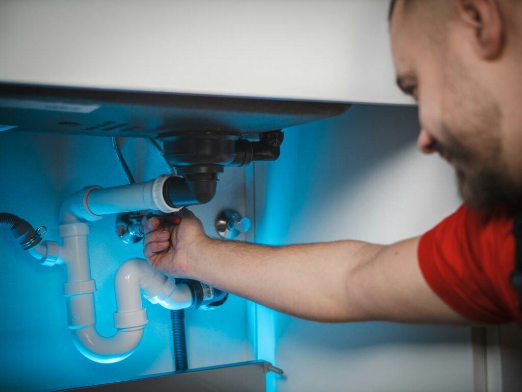 plumber tightening plumbing joints to conserve water