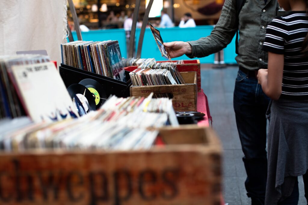 two people going through records at a yard sale