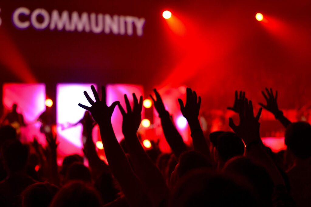 Crowd at a community concert happening at nighttime.