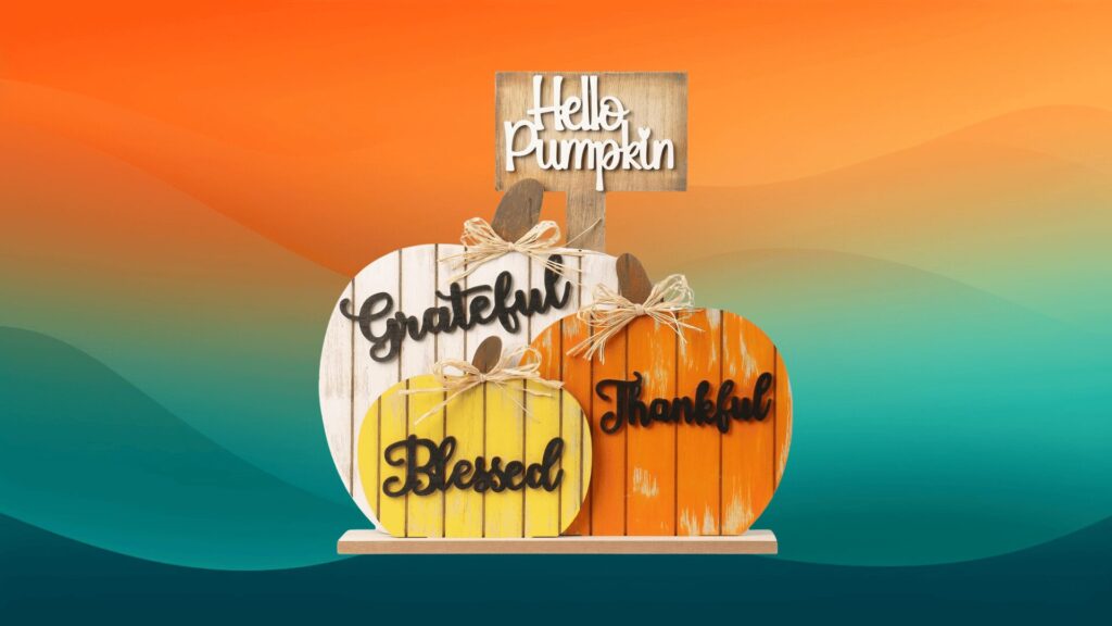 wooden pumpkin decor welcome sign in front of an orange and teal background