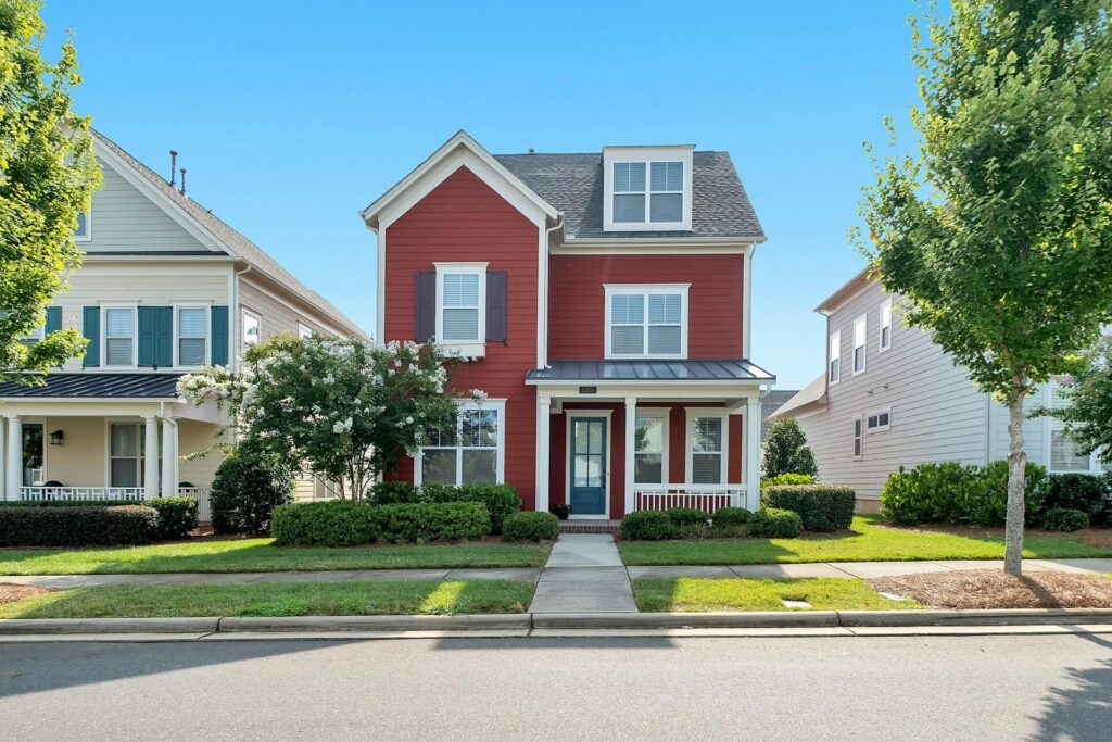 A red and white home in a neighborhood
