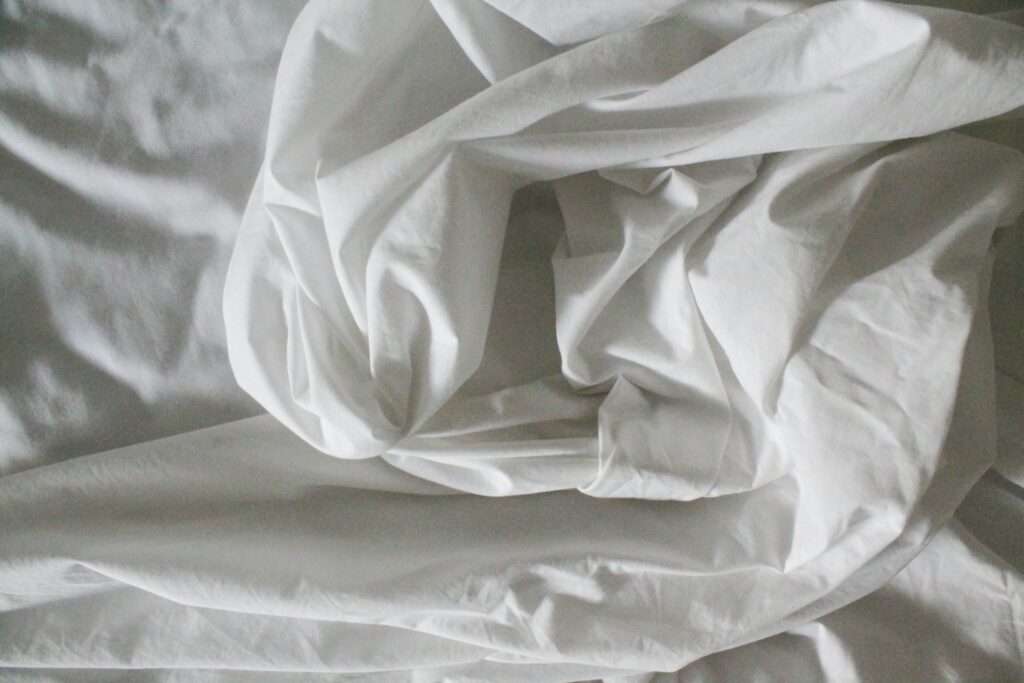 White bed sheets.