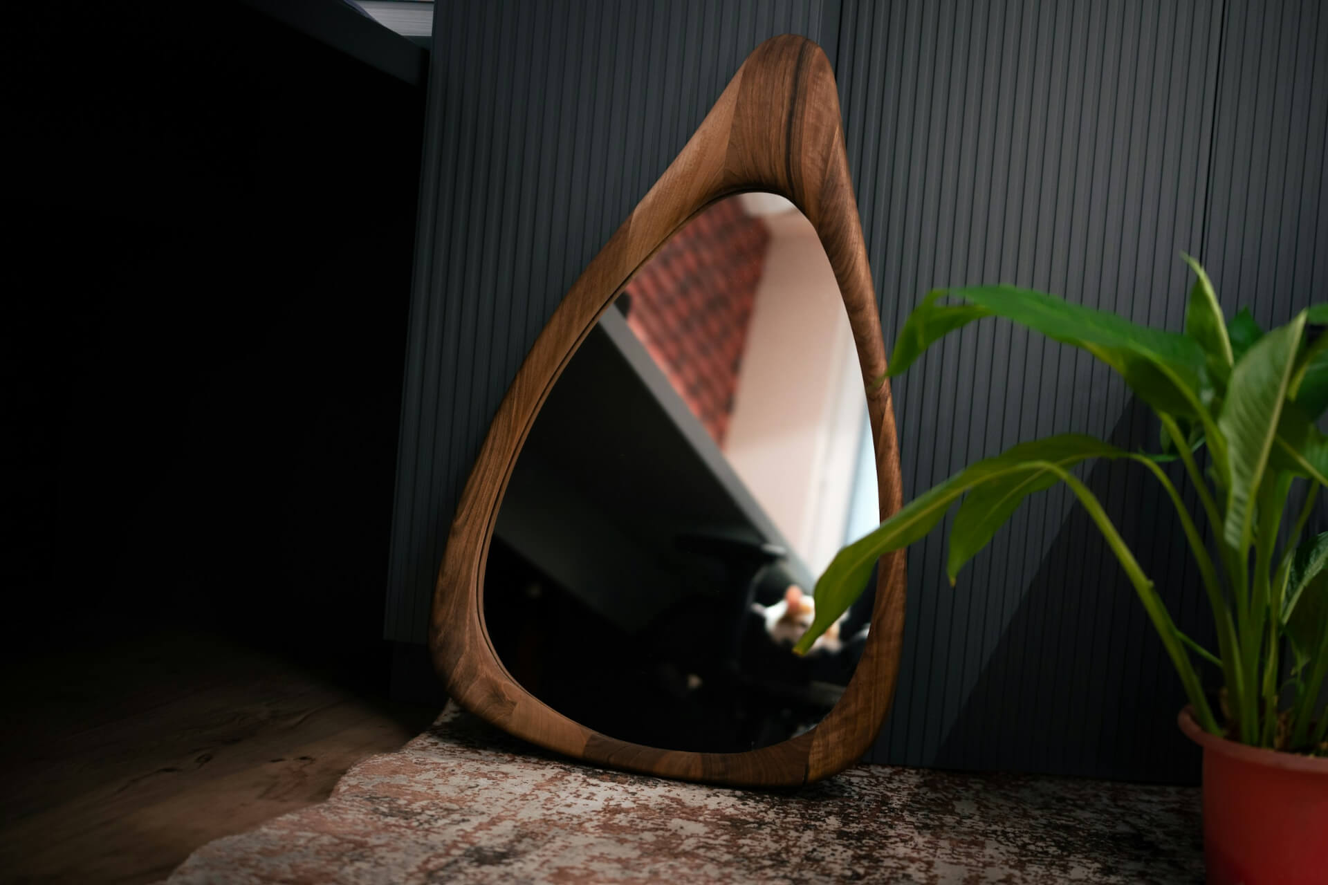 Bachelor apartments with dark colors and light-reflecting mirrors work well.