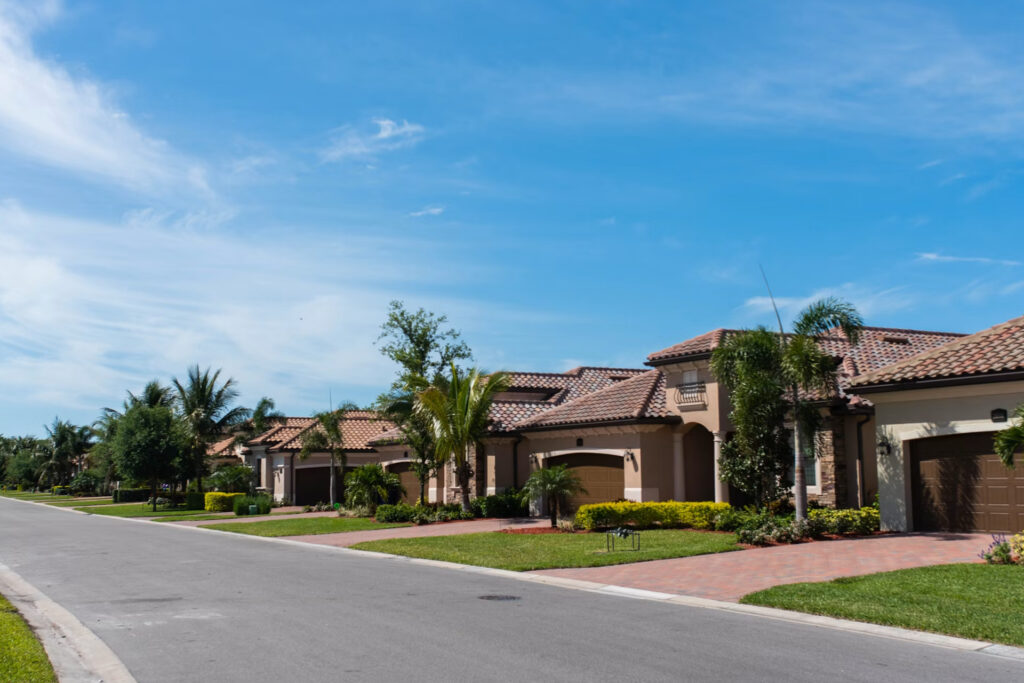 road running through neighborhood of brown houses