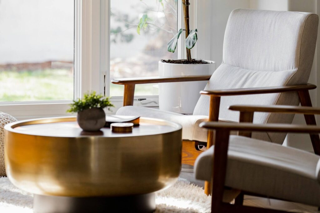 a nook with seats and a table with a warm metallic finish
