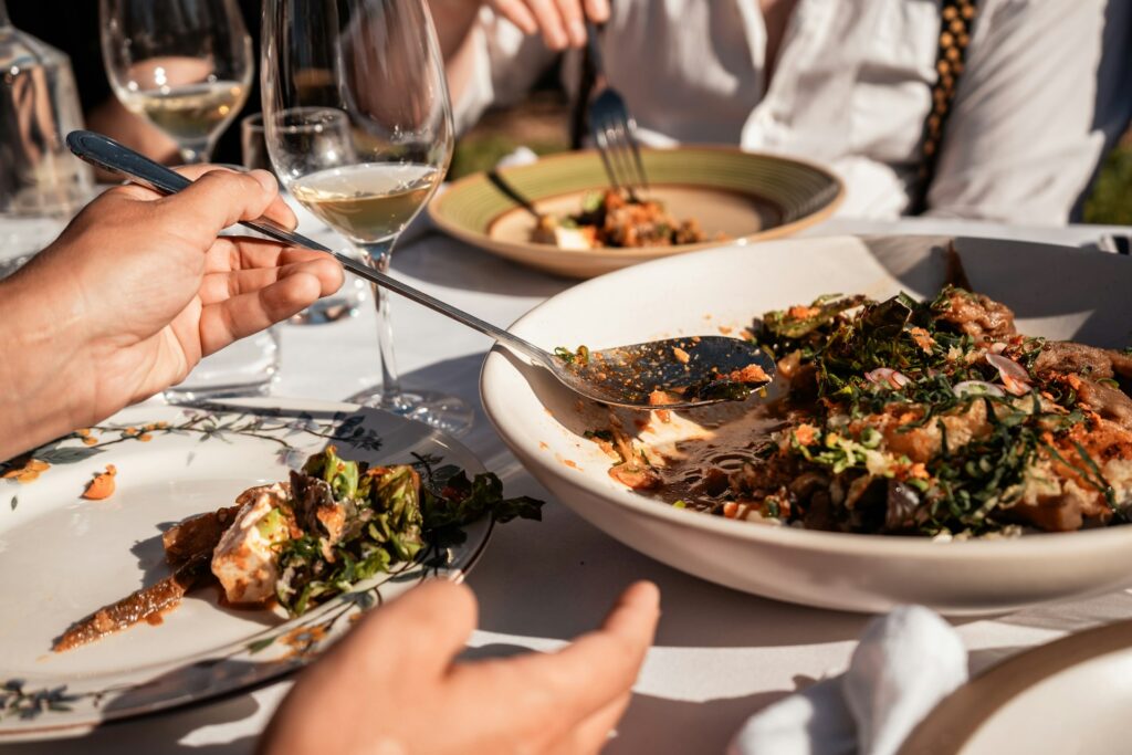 People dishing up food outdoors.