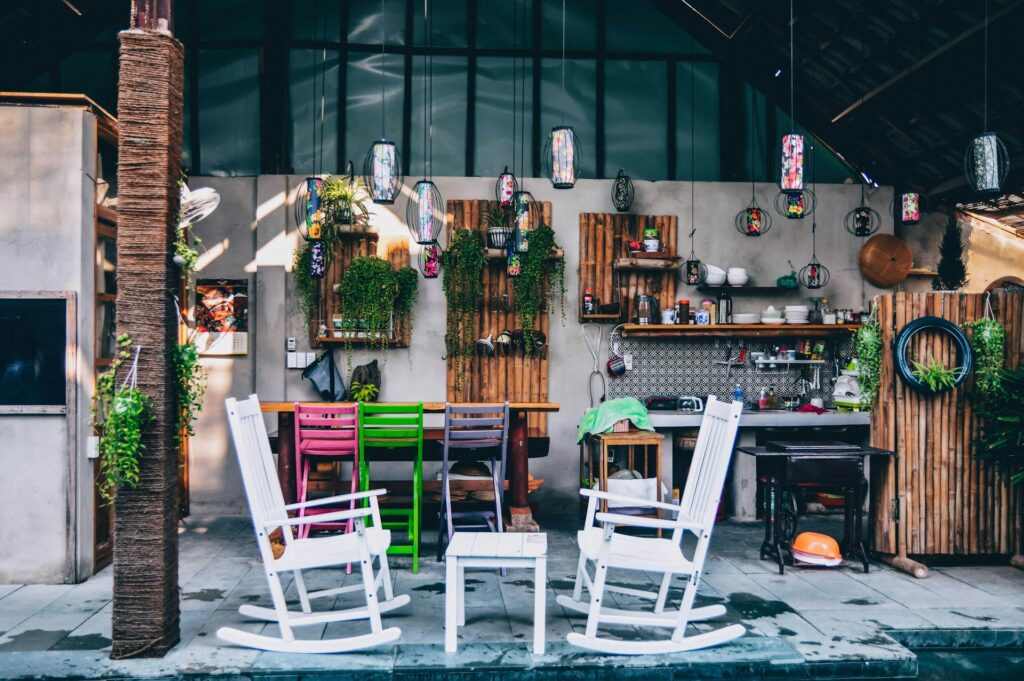 Wooden porch rockers under colorful lights