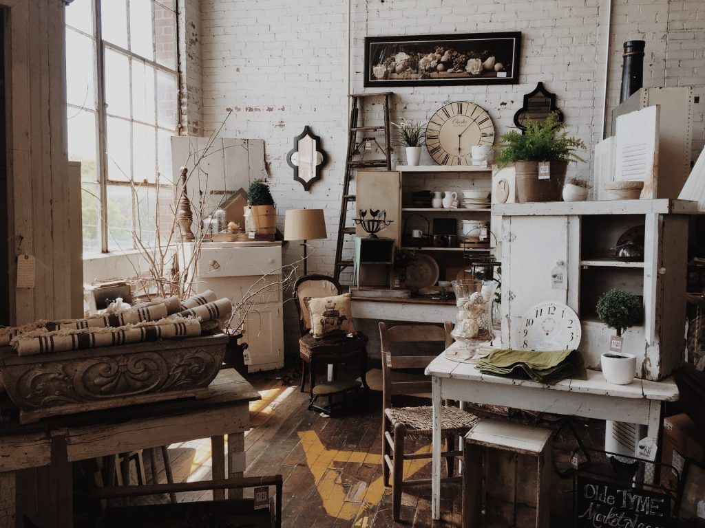 An antique store full of white and brown shabby chic decor and furniture