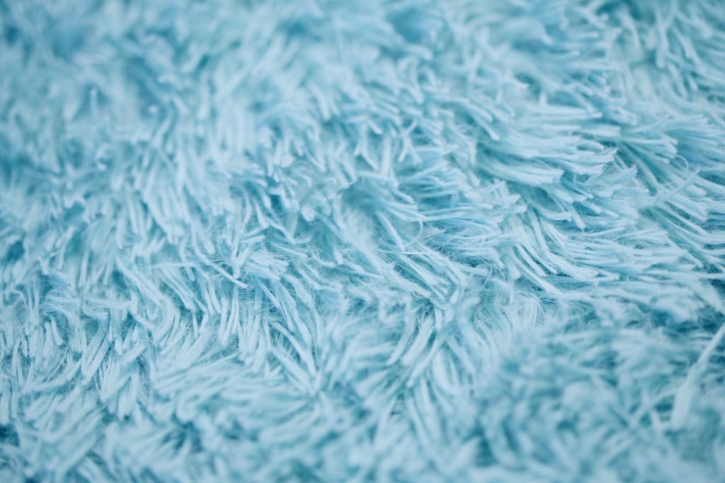 an upclose image of a baby blue shag rug