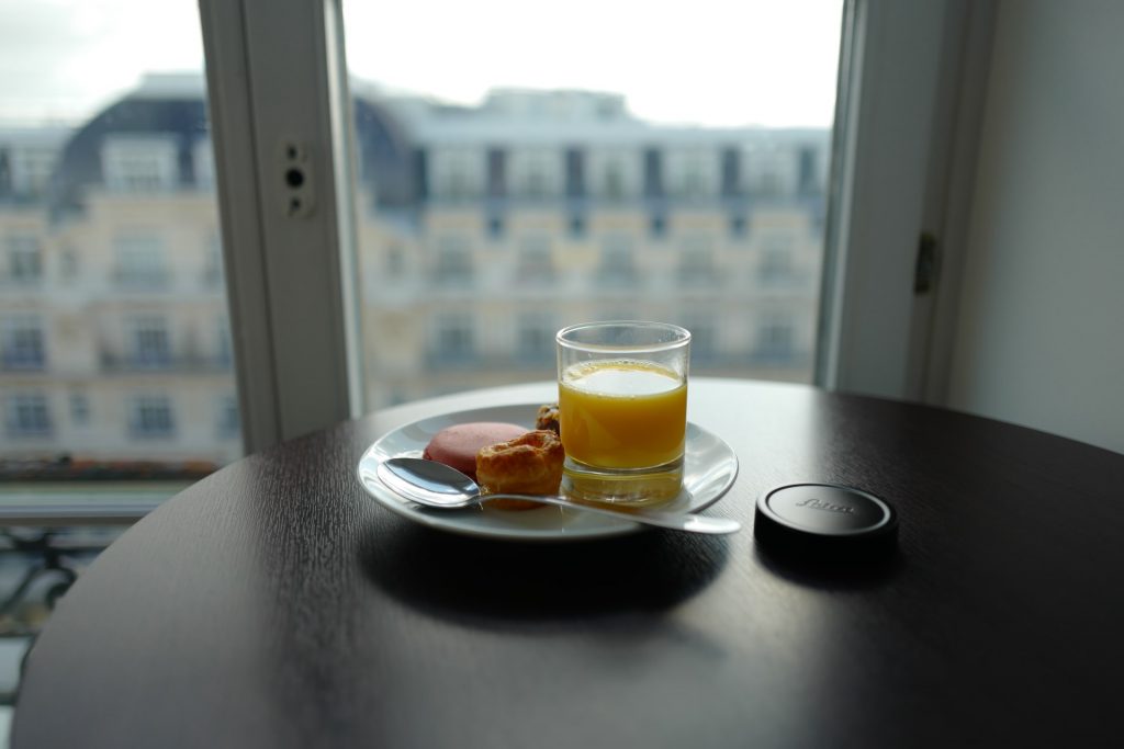 A small breakfast spread next to a large, bright glass door