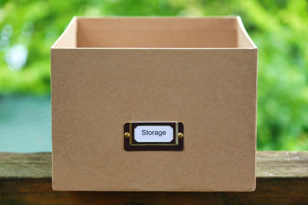Brown cardboard box with "storage" written on it